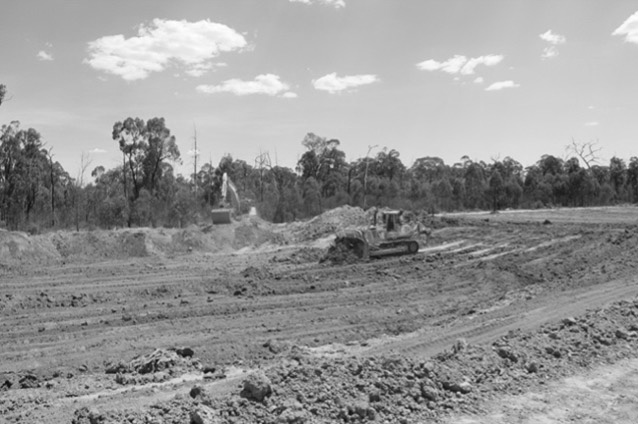 Coal seam drill cuttings being removed from a non-compliant pond, and a non-compliant water storage pond being decommissioned and rehabilitated.